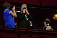 Opera singer Justino Diaz gestures to the crowd as he arrives at the 44th Kennedy Center Honors at the John F. Kennedy Center for the Performing Arts in Washington, Sunday, Dec. 5, 2021. Seated at right is folk music legend Joni Mitchell. The 2021 Kennedy Center honorees include Diaz, Mitchell, Motown Records creator Berry Gordy, "Saturday Night Live" mastermind Lorne Michaels, and actress-singer Bette Midler. (AP Photo/Carolyn Kaster)