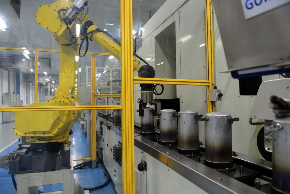 In this photograph taken on December 8, 2016, an automated robot works on an assembly line of Highly Electrical Appliances India Pvt. Ltd. at a company air-conditioner compressor plant at Matoda, some 20 kms. from Ahmedabad.  / AFP / SAM PANTHAKY        (Photo credit should read SAM PANTHAKY/AFP via Getty Images)