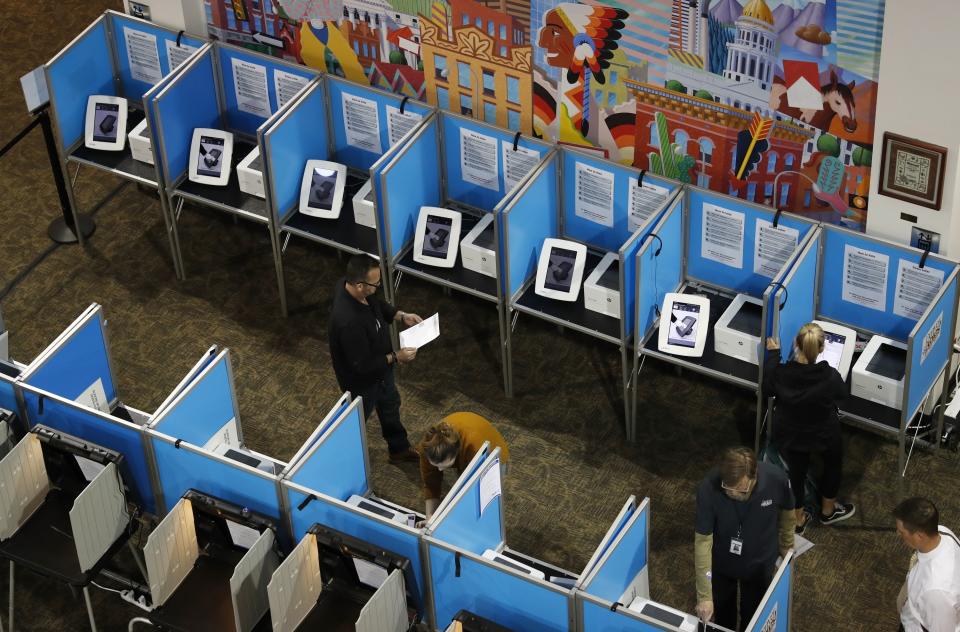 Voters fill out their ballots at the Denver Elections Division Tuesday, May 7, 2019, in Denver. Voters could make Denver the first U.S. city to decriminalize the use of psilocybin, the psychoactive substance in "magic mushrooms" if the measure passes. (AP Photo/David Zalubowski)