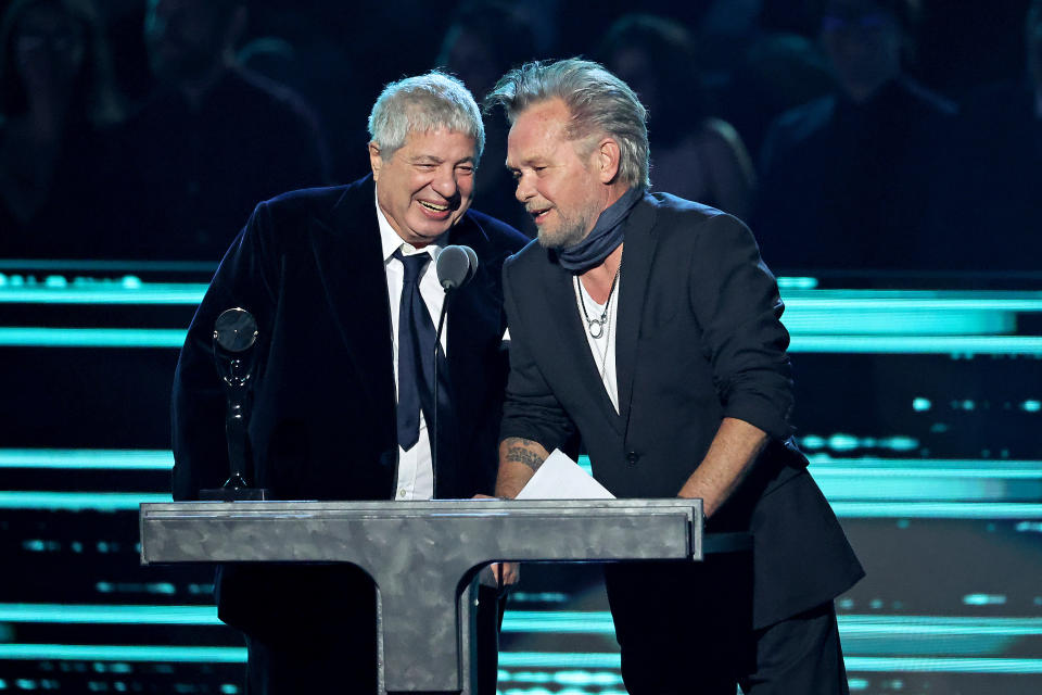 LOS ANGELES, CALIFORNIA - NOVEMBER 05: Inductee Allen Grubman (L) and John Mellencamp speak onstage during the 37th Annual Rock & Roll Hall of Fame Induction Ceremony at Microsoft Theater on November 05, 2022 in Los Angeles, California. (Photo by Amy Sussman/WireImage)