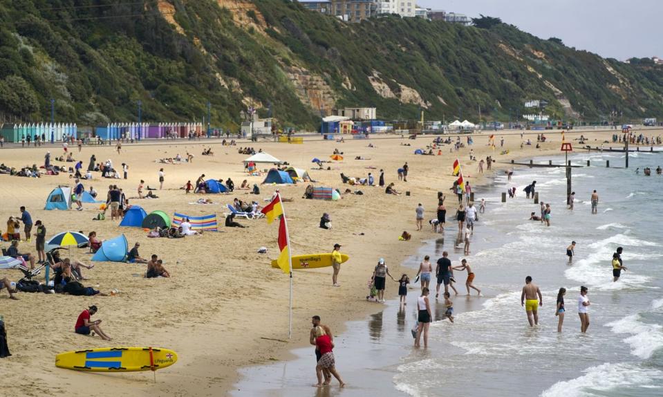 People enjoying the hot weather on Bournemouth beach after temperatures topped 40C in the UK for the first time ever (PA) (PA Wire)