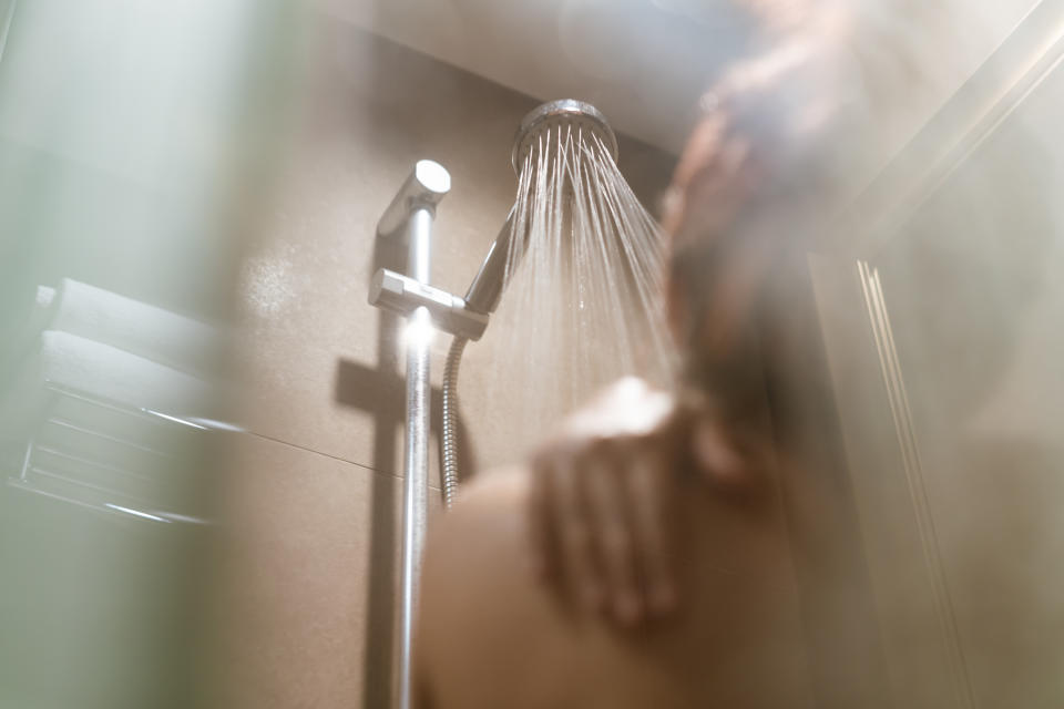 Woman taking a shower in the bathroom 