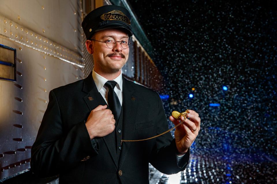 A conductor stands in the snow waiting for passengers to board Oklahoma City's "The Polar Express" Train Ride, produced by Rail Events Productions, Nov. 10, 2022. Based on the beloved book and movie, the holiday rides continue through Dec. 27 out of the Oklahoma Railway Museum in Oklahoma City.