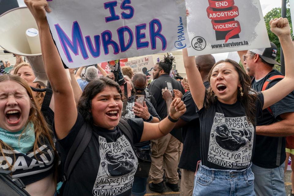 Anti-abortion protesters celebrate following Supreme Court's decision to overturn Roe v. Wade, ending the federally protected right to abortion, in Washington, Friday, June 24, 2022.