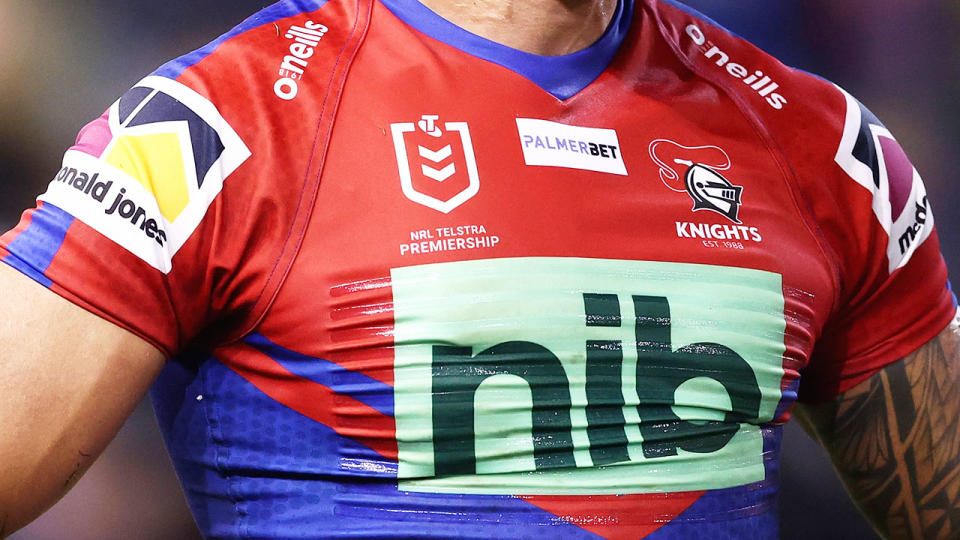 This picture shows a close up of a Newcastle Knights player wearing the club's home jersey.