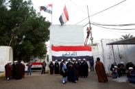 Supporters of Iraqi Shi'ite cleric Moqtada al-Sadr are seen near his home, after it was attacked, in the holy city of Najaf