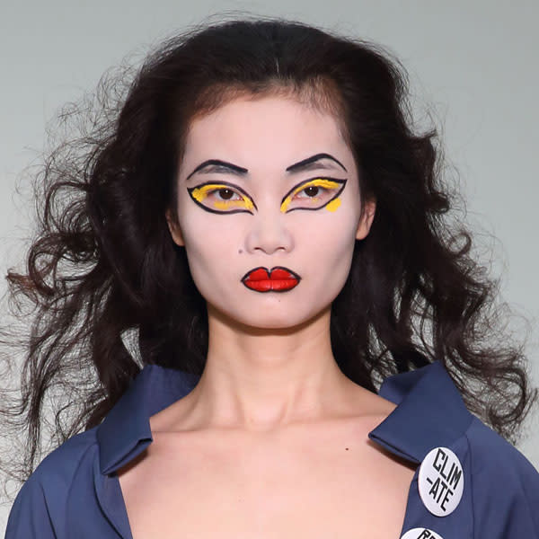 <b>Vivienne Westwood Red Label </b><br><br>Models sported ghostly white faces and vivid yellow eyeshadow.<br><br>Image © Getty