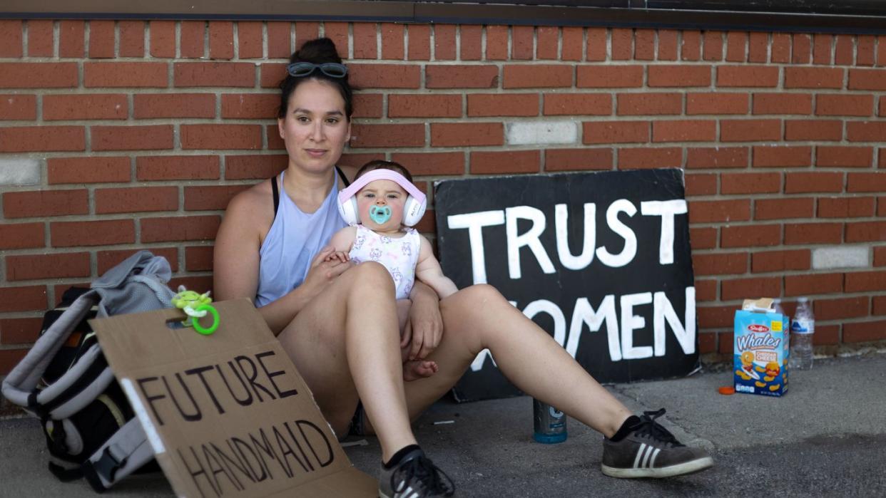 rachel humberger, 30, of toledo holds her own 9 month old