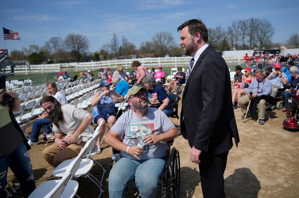 D Vance stops to talk to Michaeal Emans of St. Marys prior to a rally with former President Donald Trump at the Delaware County Fairgrounds. Mandatory Credit: Adam Cairns-The Columbus Dispatch