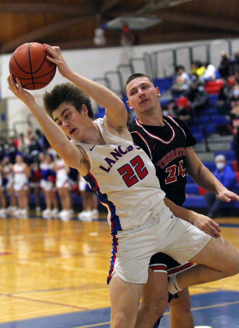 Churchill’s Pete Pennington and Thurston’s Jake Newell battle for a rebound during Friday’s Midwestern League basketball game.