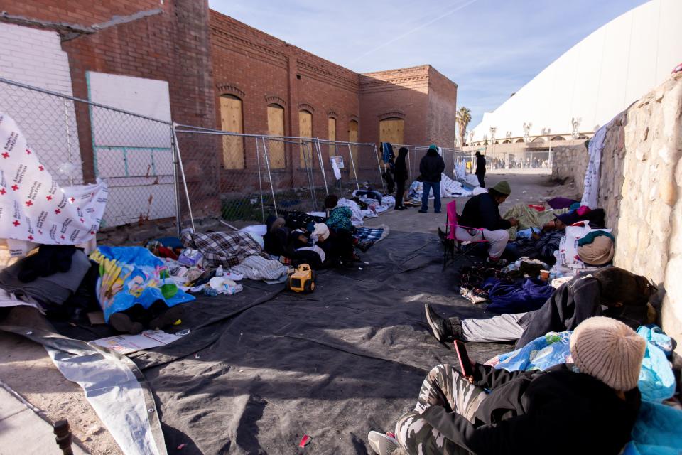 Volunteers bring food, water, blankets, clothes, etc., to migrants who sleep on the streets of El Paso, Texas, on Saturday, Dec. 17, 2022, after being released after crossing into the U.S.