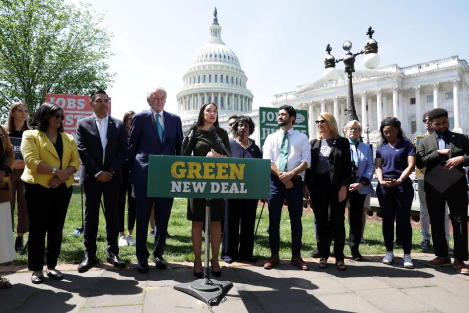 Rep. Alexandria Ocasio-Cortez (center) speaks outside the Capitol in April with Sen. Ed Markey standing next to her as they reintroduce the Green New Deal Resolution. (Photo by Alex Wong/Getty Images)