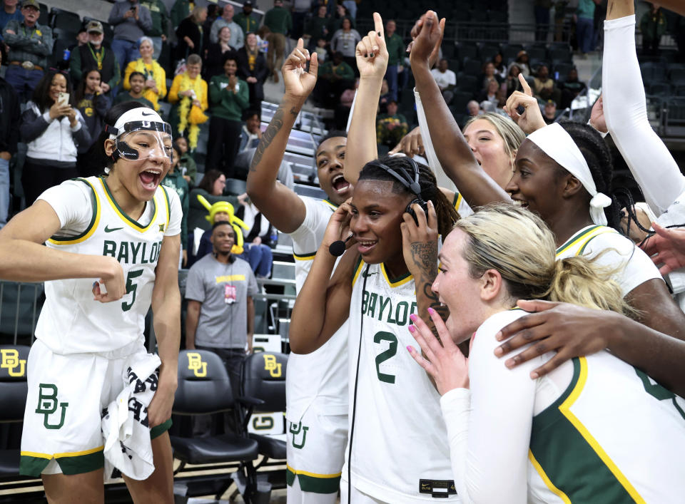 Baylor guard Yaya Felder is swarmed by teammates while giving an interview after scoring her 1,000 point against Houston following an NCAA college basketball game, Saturday, Jan. 6, 2024, in Waco, Texas. (Rod Aydelotte/Waco Tribune-Herald via AP)