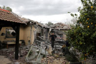 A police sapper inspects a damaged house that was hit by a rocket north of Tel Aviv Israel March 25, 2019. REUTERS/ Ammar Awad