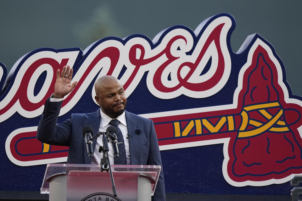 Former Atlanta Braves player, Andruw Jones waves to the crowd as he is honored, Saturday, Sept. 9, 2023, in Atlanta. Jones who won 10 Gold Gloves in a career that began with 12 seasons in Atlanta, became the 11th Braves player or manager to have his number retired on Saturday night. The honor could add momentum to his candidacy for the Baseball Hall of Fame. Jones' 25 was retired before the Braves' game against the Pittsburgh Pirates. (AP Photo/Brynn Anderson)