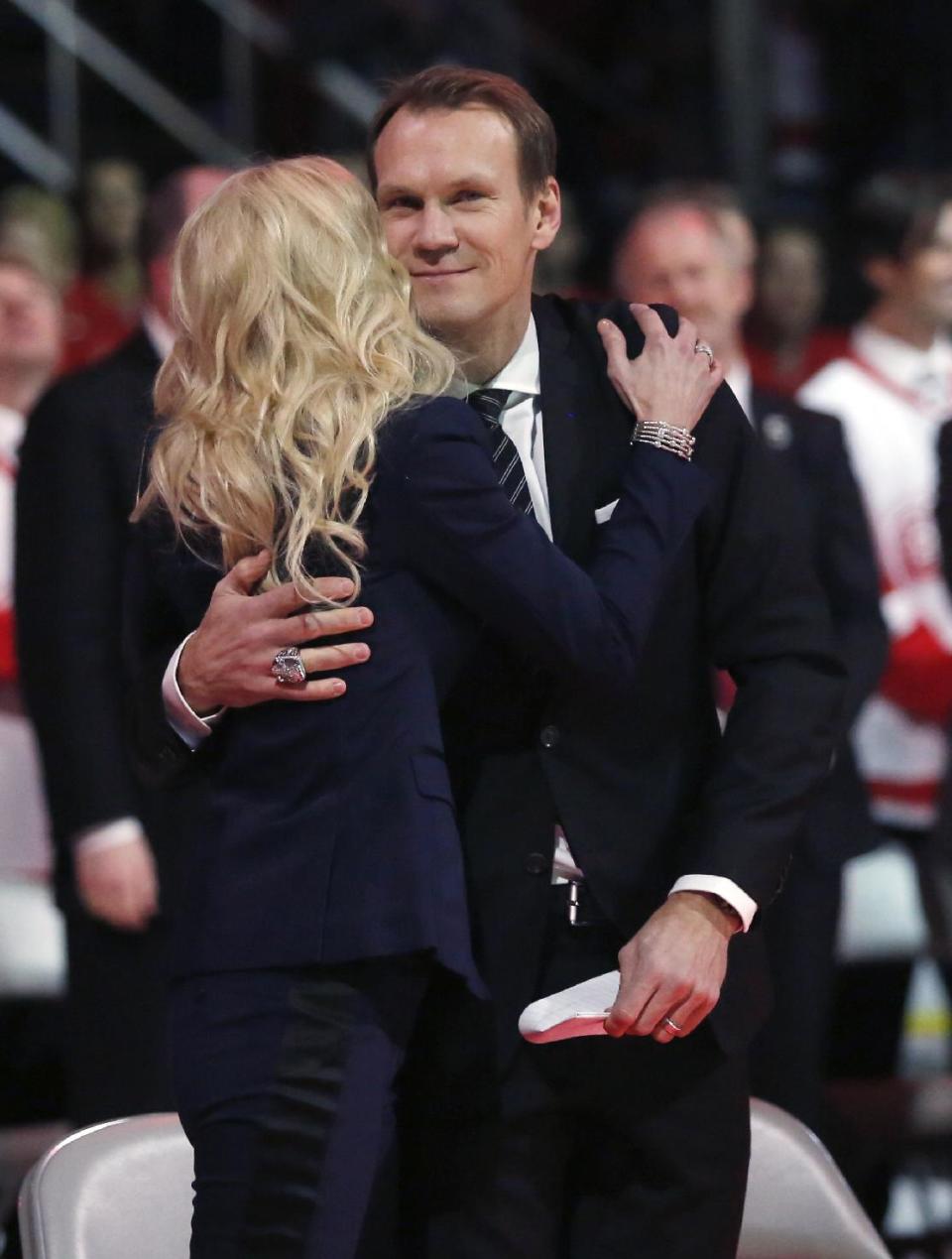 Former Detroit Red Wing Nicklas Lidstrom receives a hug from his wife Annika after addressing the crowd during the retirement of his No. 5 before an NHL hockey game between the Detroit Red Wings and Colorado Avalanche at Joe Louis Arena, Thursday, March 6, 2014, in Detroit. (AP Photo/Duane Burleson)