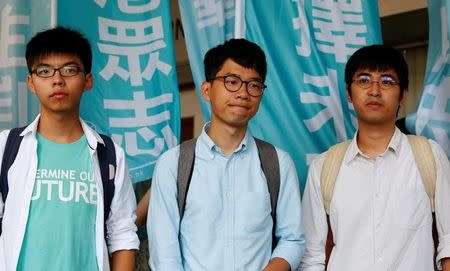 Student leaders (from L) Joshua Wong, Nathan Law and Alex Chow pose before a verdict, on charges of inciting and participating in an illegal assembly in 2014 which led to the "Occupy Central" pro-democracy movement, outside a court in Hong Kong July 21, 2016. REUTERS/Bobby Yi