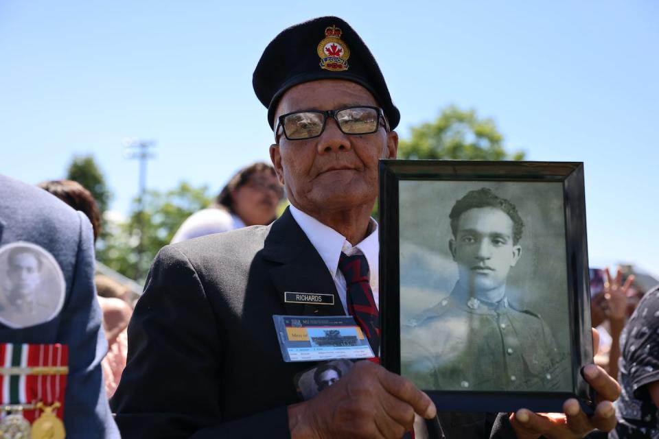 Peter Richards holds a picture of battalion member Percy James Richards during the national apology to the No. 2 Construction Battalion in Truro, N.S. on July 9, 2022. THE CANADIAN PRESS/Riley Smith