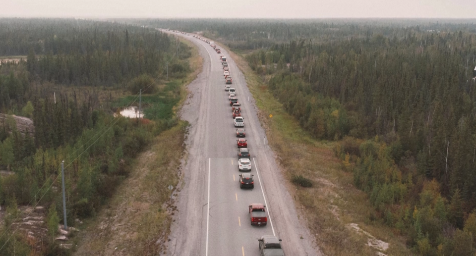 An arial shot of Highway 3, the only two-lane road out of Yellowknife. It's choked with cars.