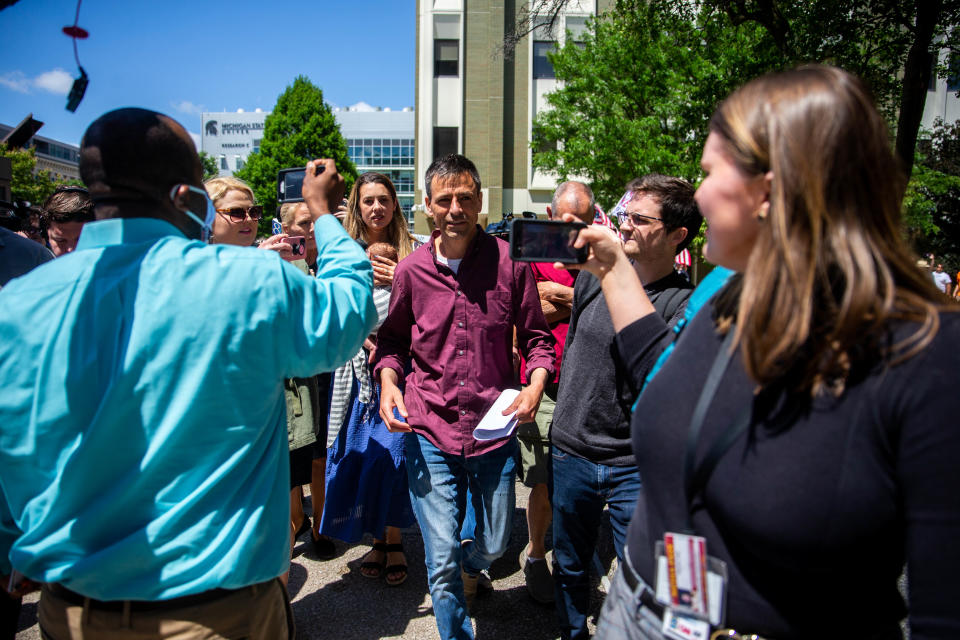 Michigan GOP gubernatorial candidate Ryan Kelley exits the courthouse surrounded by a barrage of media and supporters after his arraignment in connection to Jan. 6 Thursday, June 9, 2022, at the Gerald R. Ford Federal Building.