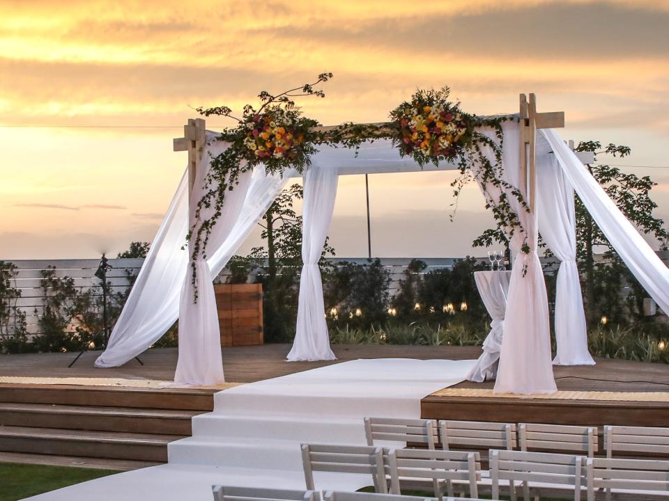 Wedding alter and chairs in front of sunset
