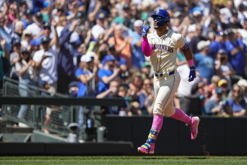 Seattle Mariners' Julio Rodríguez reacts as he jogs the bases after hitting a two-run home run against the Oakland Athletics during the second inning of a baseball game Sunday, May 12, 2024, in Seattle. (AP Photo/Lindsey Wasson)