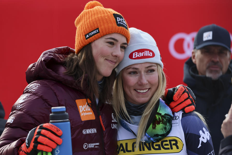 United States' Mikaela Shiffrin, right, winner of an alpine ski, women's World Cup giant slalom race, is hugged by Slovakia's Petra Vlhova, in Kranjska Gora, Slovenia, Sunday, Jan. 8, 2023. Shiffrin matched Lindsey Vonn's women's World Cup skiing record with her 82nd win Sunday. (AP Photo/Marco Trovati)