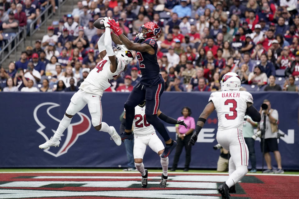 Arizona Cardinals safety Jalen Thompson (34) intercepts a pass in the end zone intended for Houston Texans wide receiver Nico Collins (12) in the first half of an NFL football game in Houston, Sunday, Nov. 19, 2023. Budda Baker (3) looks on a the play. (AP Photo/Eric Christian Smith)