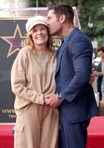 <p>Leon Bennett/Getty Images</p> Zac Efron and his mom Starla Baskett at his Hollywood Walk of Fame ceremony