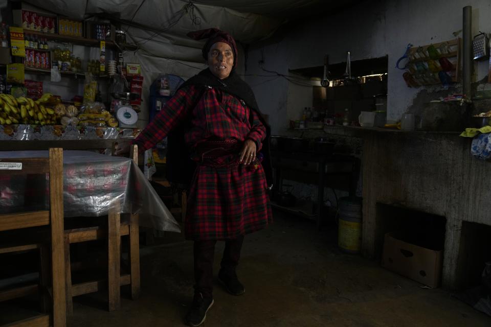 Maria Acevedo speaks during an interview at her restaurant in Tupe, Peru, Tuesday, July 19, 2022. Acevedo, like many other residents of Tupe, where the indigenous language Jaqaru is still spoken, voted for Pedro Castillo for president last year, drawn in part by the possibility of seeing someone with rural roots like her lead the nation. (AP Photo/Martin Mejia)