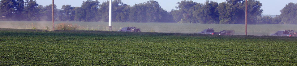 <p>Mississippi wildlife law officers form a caravan as they bring a special response trailer and a number of all terrain vehicles along a county farm road adjacent to U.S. Highway 82, as they head to the wreckage of a military refueling tanker aircraft that crashed Monday in a soybean field near Itta Bena, Miss., on the western edge of Leflore County, Tuesday, July 11, 2007. (Photo: Rogelio V. Solis/AP) </p>