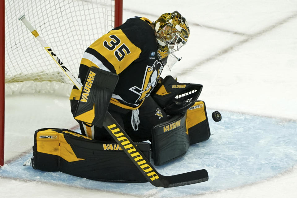 Pittsburgh Penguins goaltender Tristan Jarry (35) makes a save against the New York Islanders during the first period of an NHL hockey game in Pittsburgh, Monday, Feb. 20, 2023. (AP Photo/Matt Freed)
