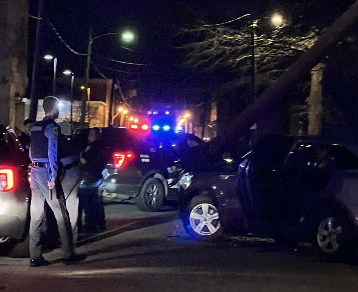 A Virginia State Police trooper walks toward the wreckage of a 2022 Kia SUV Thursday, Feb. 15, 2024, at the intersection of Liberty and Harrison streets in Petersburg. The wrecked vehicle belonged to a man who led state police on a pursuit of more tha 20 miles on Interstate 85 before veering off into the city.