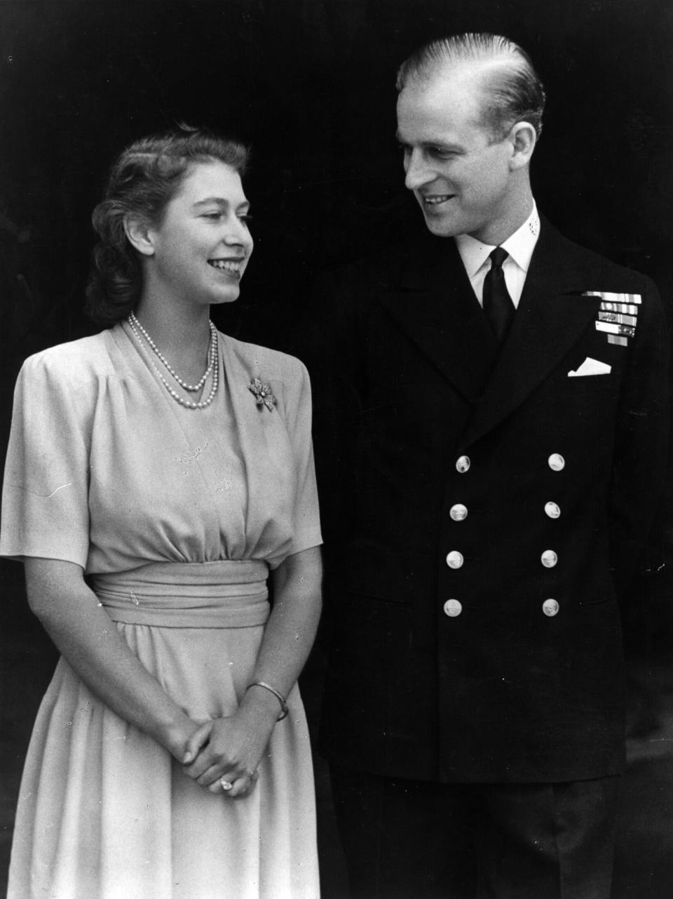 1947:  H R H Princess Elizabeth and Philip Mountbatten, Duke of Edinburgh, on the occasion of their engagement at Buckingham Palace in London.  (Photo by Fox Photos/Getty Images)