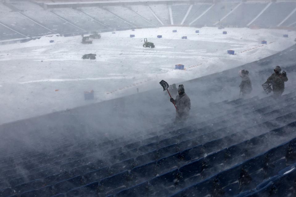 Workers remove snow from Highmark Stadium in Orchard Park, N.Y. (AP)