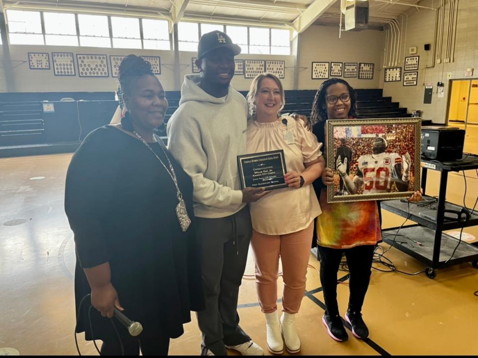 Willie Gay Jr. is awarded a plaque and framed photo by West Oktibbeha County Elementary School teachers for helping the Kansas City Chiefs win Super Bowl 57 against the Philadelphia Eagles.