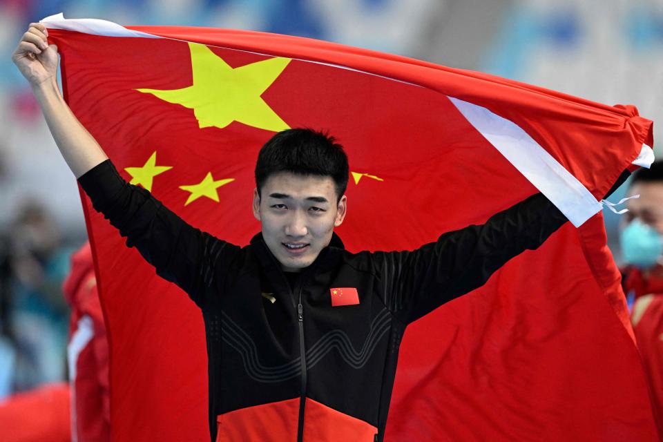 Tingyu Gao celebrates his triumph at the National Speed Skating Oval (AFP via Getty Images)