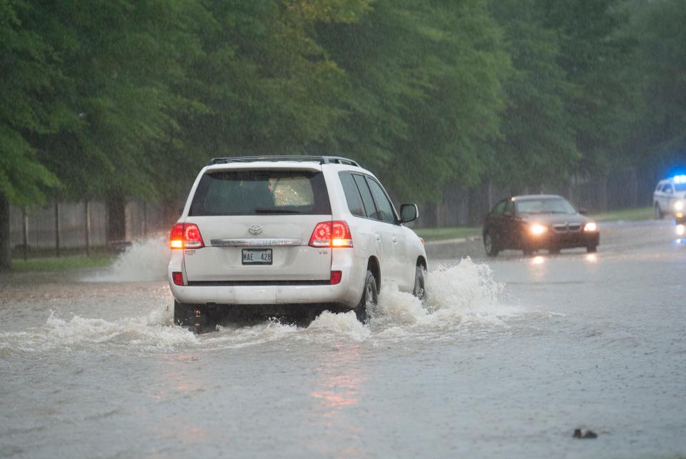 Some drivers decide to attempt going through flood waters on the east end of High Street Thursday morning regardless of warnings by Jackson Police cruisers with flashing lights. Thunderstorms are expected to continue throughout the morning with rain tappering off this evening. Thursday, May 9, 2019