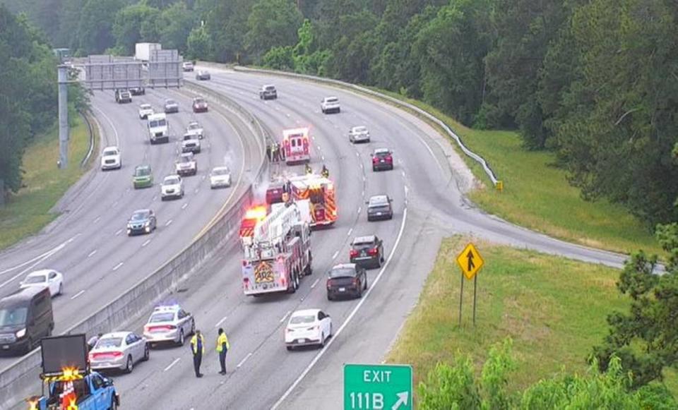 Lanes on a highway are closed as emergency responders deal with a vehicle fire.