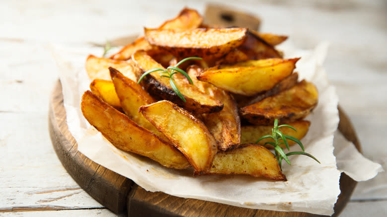 Steak cut fries on paper with herbs