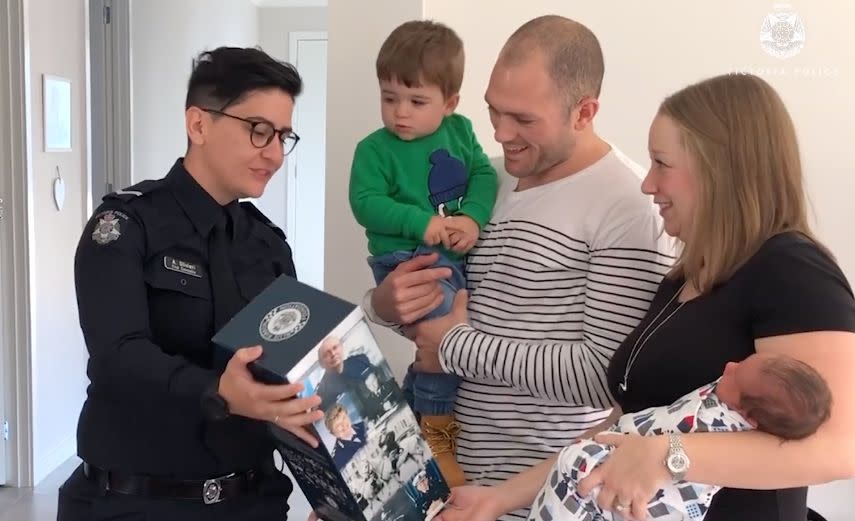 Cst Olivieri brings gifts for the Sherwood family and their little boy. Source: Victoria Police
