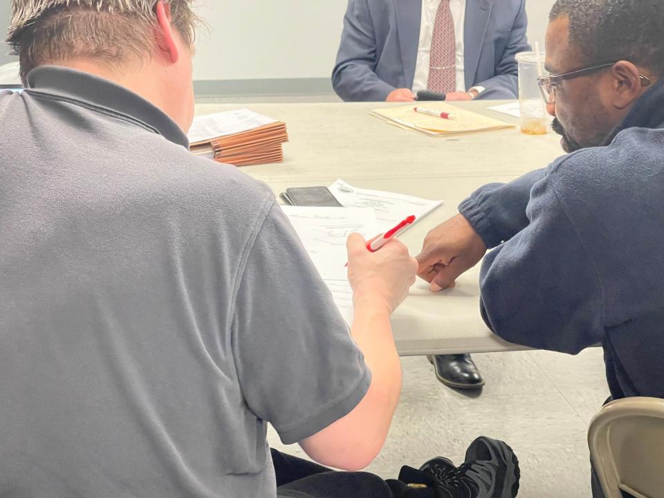 Portage township board secretary Ryan Hill, left, and board member Muhammad Shabazz sign Resolution 10-2024 to adopt the St. Joseph County Fire Territory on March 28, 2024, at Portage’s Fire Station 41, 23626 Fillmore Road, South Bend.