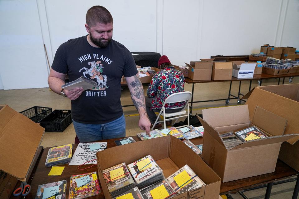 Spencer Brickey sorts through rare cult films that are part of a collection the Alamo Drafthouse acquired in 2020 when the South Austin location of Austin video store Vulcan Video shuttered. Many of the titles have never been digitized. "If they were thrown out, they'd be gone," Brickey said. "This is still art. Somebody created this. We're making sure the films survive and live on."