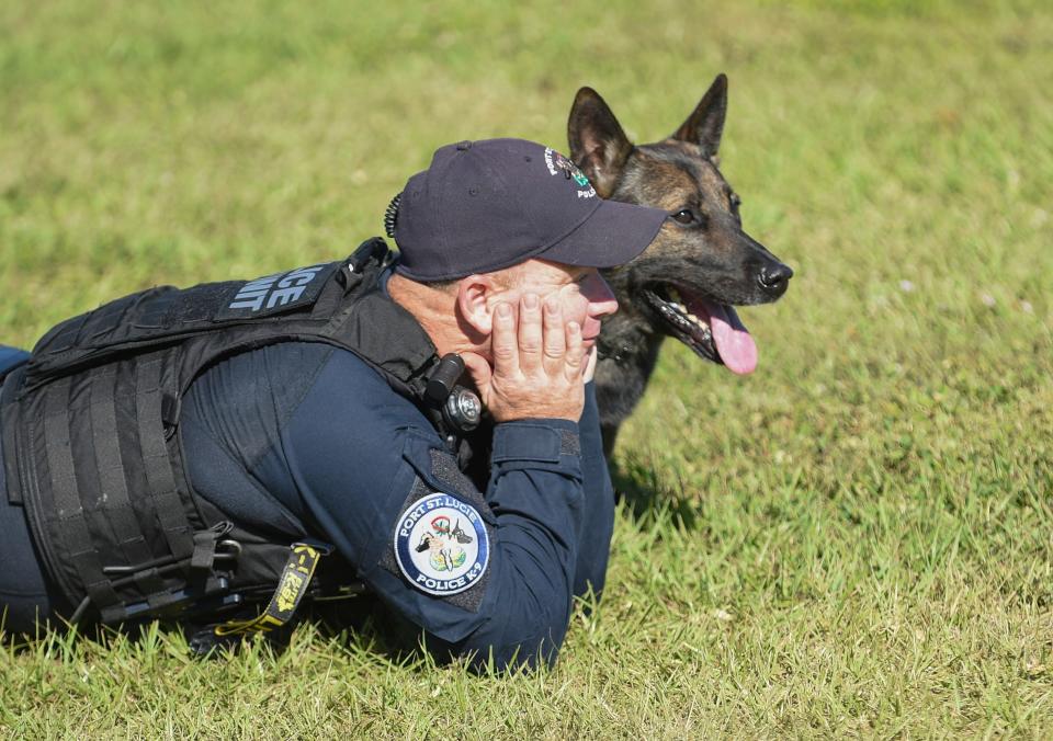 Port St. Lucie Police K9 Officer Robbie Gibbins rests with his dog Dingo after a brief workout at the Port St. Lucie Police obstacle course along South Macedo Boulevard on Tuesday, Jan. 18, 2022, in Port St. Lucie. Dingo has been assigned to Gibbons since March 2015, and will officially retire Wednesday and become a part of Gibbins' family.