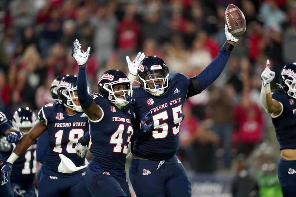 Oct 29, 2022; Fresno, California, USA; Fresno State Bulldogs defensive tackle Leonard Payne Jr. (55) celebrates next to defensive back Morice Norris (43) after recovering a fumble against the San Diego State Aztecs in the second quarter at Valley Children’s Stadium. Mandatory Credit: Cary Edmondson-USA TODAY Sports