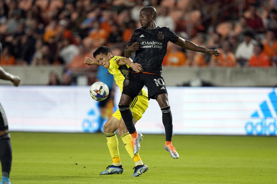 Houston Dynamo's Fafà Picault (10) battles Nashville SC's Sean Davis for the ball during the second half of a soccer match Saturday, May 14, 2022, in Houston. (AP Photo/David J. Phillip)