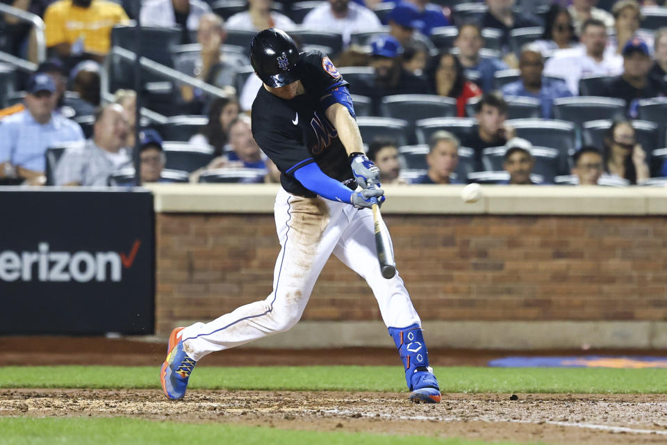 New York Mets' Mark Canha hits an RBI-double to score Mets' Darin Ruf against the Colorado Rockies during the sixth inning of a baseball game on Friday, Aug. 26, 2022, in New York. (AP Photo/Jessie Alcheh)