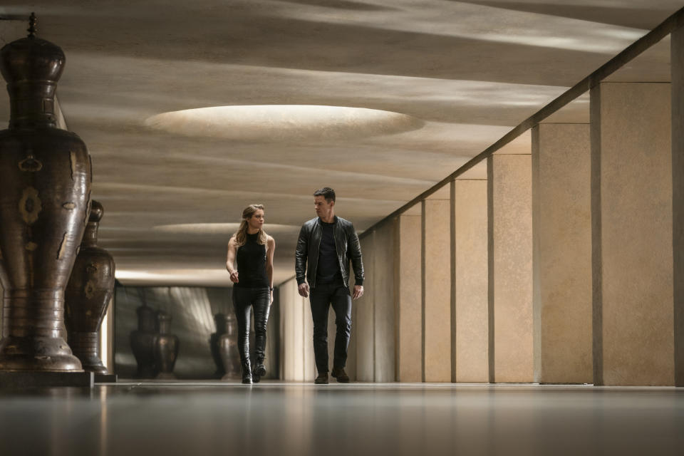 This image released by Paramount Plus shows Sophie Cookson, left, and Mark Wahlberg in a scene from "Infinite." (Peter Mountain/Paramount+ via AP)