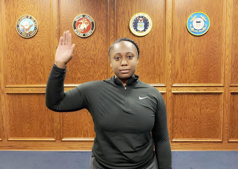 In this photo provided by the Commander Navy Recruiting Command of the United States Navy, Tierney Crutcher is sworn into the U.S Navy as a Navy seaman recruit, in Memphis, Tenn., on Wednesday, Sept. 11, 2019, two days shy of her 18th birthday. September 11 has always been part of Crutcher's life story. Her mom, Tiffany Smith, went into labor with her on Sept. 11, 2001, pushing as the news monopolized hospital TVs. (US Navy Commander Navy Recruiting Command via AP)