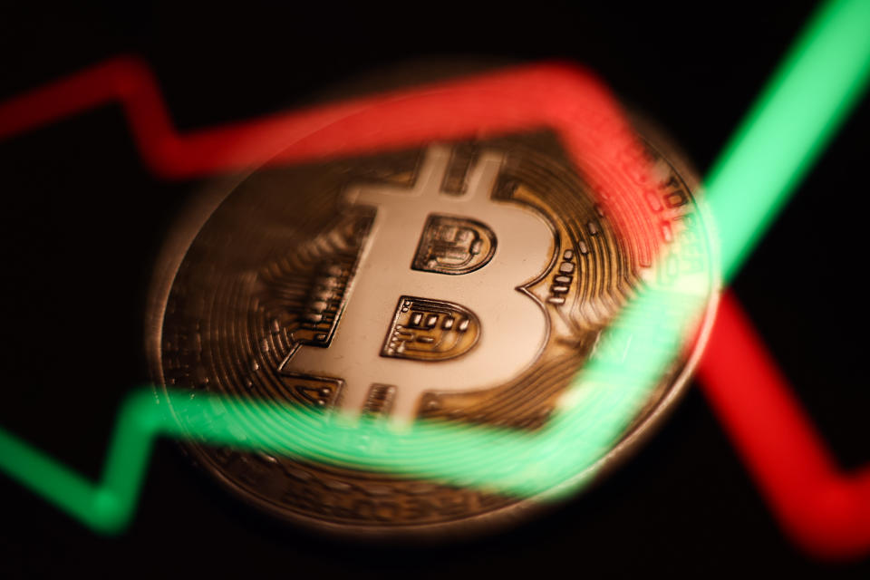 An illustrative stock chart and representation of Bitcoin are seen in this multiple exposure illustration photo taken in Krakow, Poland March 21, 2023. (Photo by Jakub Porzycki/NurPhoto via Getty Images)
